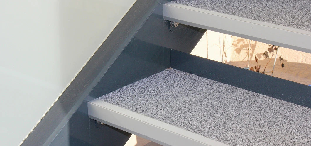 Außentreppe aus Aluminium mit rutschfesten balkoFLOOR Treppenstufen in grau-weißer Granit-Optik für einen sicheren und modernen Terrassenzugang